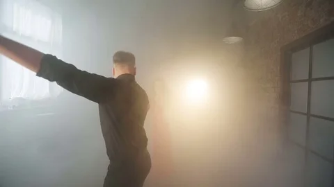 A bright couple performs a beautiful tango in the smoke. Video stock 76463376