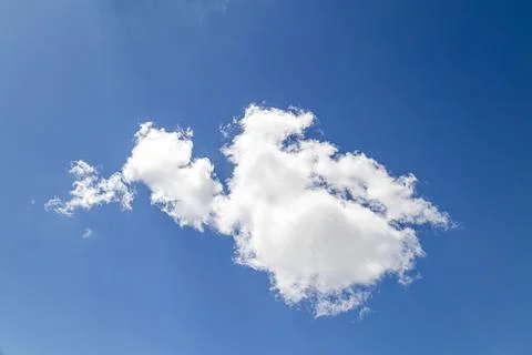 Bright cumulus cloud formation against deep vibrant atmospheric blue sky Фото