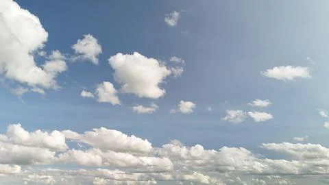 Bright Cumulus Clouds in Blue Sky Above Distant Countryside Horizon Stock Photos