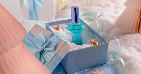 Bright decorations surround the perfume Christmas gift. Stock Footage 345459600