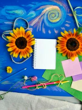 Bright decorative composition of art materials, notepad and flowers Stock Photos