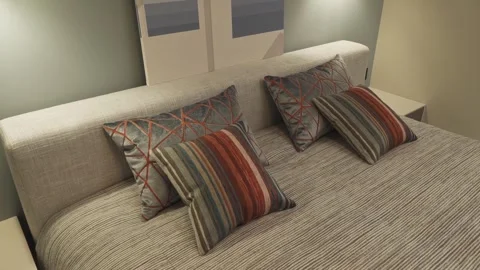 Bright decorative pillows on the bed Stock Footage 275170295
