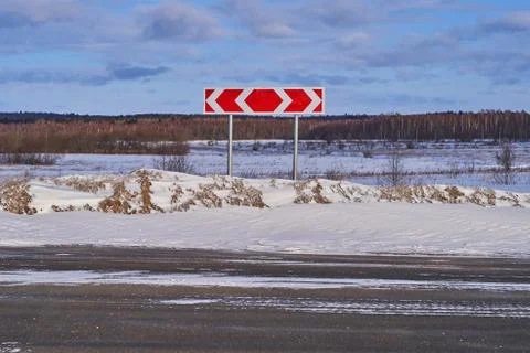 Bright direction indicator on an empty winter road Stock Photos