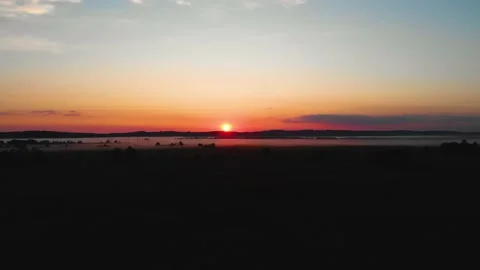 The bright disk of the sun in the blue sky slowly rises. Fog Stock Footage 199018278