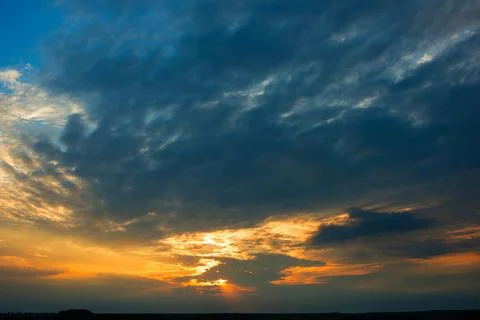 Bright dramatic sky with clouds at sunset Stock Photos