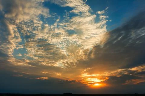 Bright dramatic sky with clouds at sunset Stock Photos