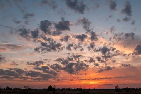 Bright dramatic sunset in the countryside Stock Photos