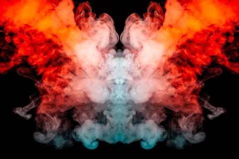 The bright dynamic pattern of explosive fiery smoke illuminated in blue orang Stock Photos