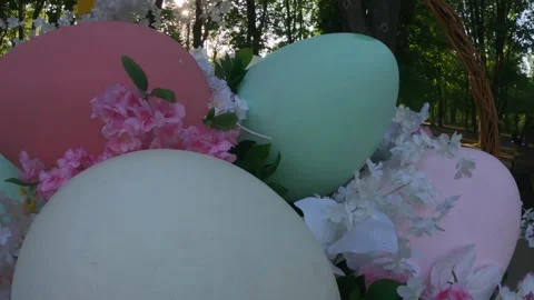 Bright Easter decorations on park paths colorful eggs fresh flowers and baskets Stock Footage 310740779