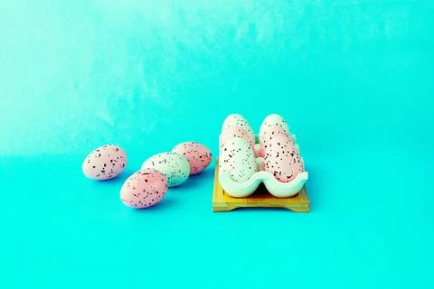 Bright easter eggs on a blue plain surface, easter decor Stock Photos