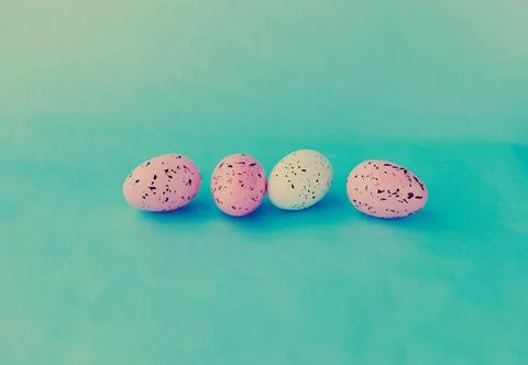 Bright easter eggs on a blue plain surface, easter decor Stock Photos