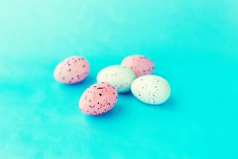 Bright easter eggs on a blue plain surface, easter decor Stock Photos