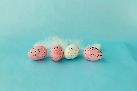 Bright easter eggs on a blue plain surface, easter decor Stock Photos