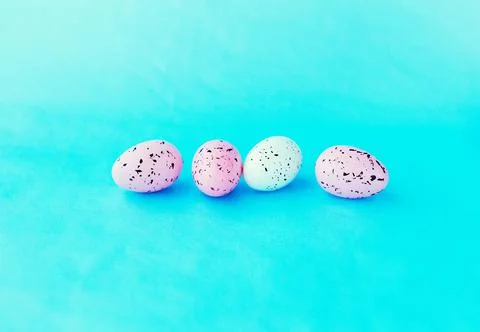 Bright easter eggs on a blue plain surface, easter decor Stock Photos