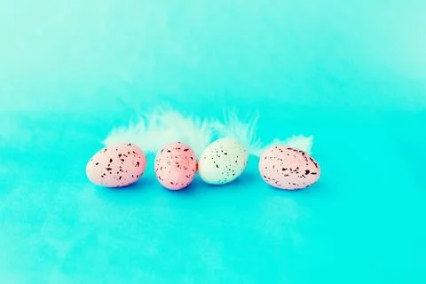 Bright easter eggs on a blue plain surface, easter decor Stock Photos