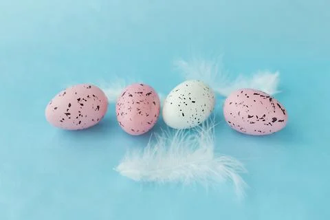 Bright easter eggs on a blue plain surface, easter decor Stock Photos