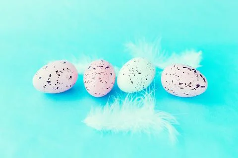 Bright easter eggs on a blue plain surface, easter decor Stock Photos