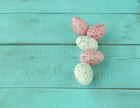 Bright easter eggs on a blue plain surface, easter decor Stock Photos