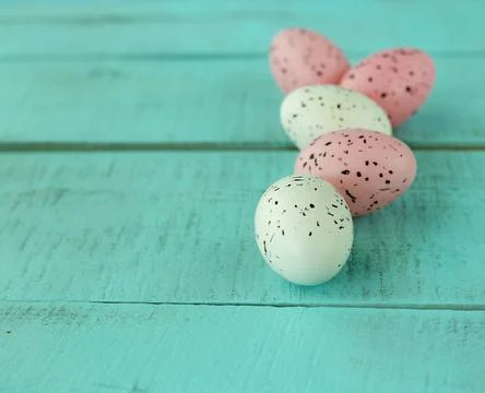 Bright easter eggs on a blue plain surface, easter decor Stock Photos