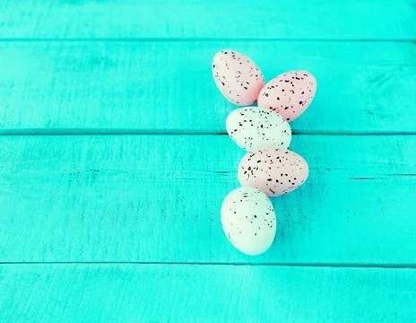 Bright easter eggs on a blue plain surface, easter decor Stock Photos