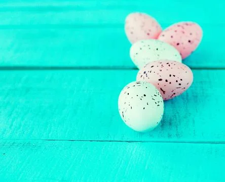 Bright easter eggs on a blue plain surface, easter decor Stock Photos