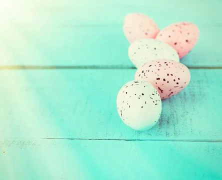 Bright easter eggs on a blue plain surface, easter decor Stock Photos
