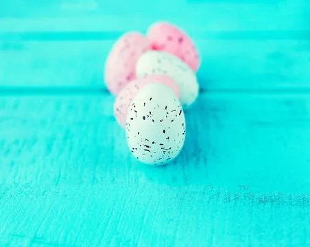 Bright easter eggs on a blue plain surface, easter decor Stock Photos
