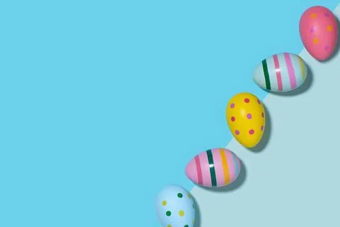 Bright Easter eggs in retro style on a blue background with copy space. Stock Photos