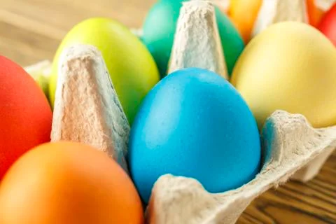 Bright Easter eggs in a special stand. Happy Easter. Close-up, blurred backgr Stock Photos