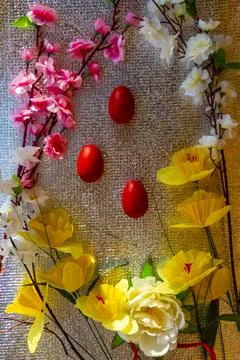 Bright Easter silver background decorated with ribbons of flowers and red egg Stock Photos