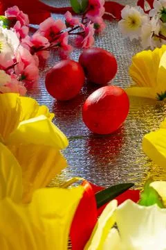 Bright Easter silver background decorated with ribbons of flowers and red egg Stock Photos