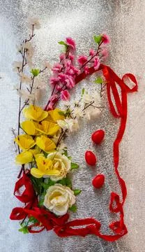 Bright Easter silver background decorated with ribbons of flowers and red egg Stock Photos