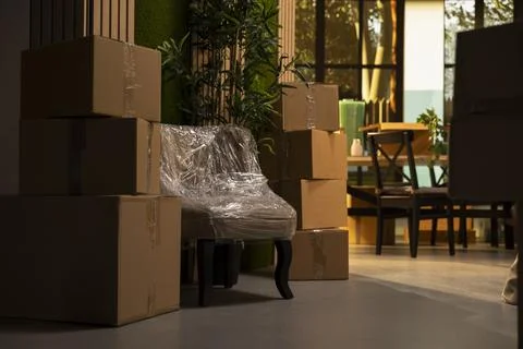 Bright empty house with cardboard boxes and wrapped belongings Stock Photos