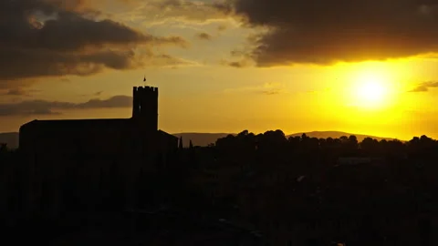 Bright Evening Sun Over Tower Silhouette with Clouds and Distant Hills Видео 256174538