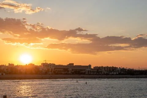 Bright evening sun setting over the city Stock Photos
