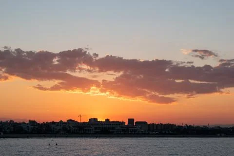 Bright evening sun setting over the city Stock Photos