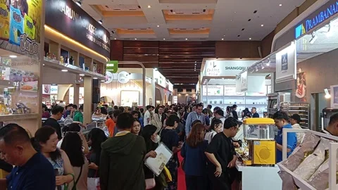 A bright exhibition hall filled with a crowd of shoppers and vendors Stock Footage 341388988