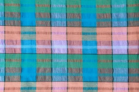 Bright fabric in a multi-colored cage. Checkered cotton fabric as background Stock Photos