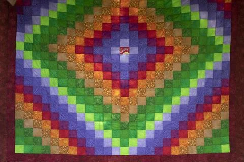 Bright fabric texture. Quilt. Patchwork. Collage of pieces of fabric. Brigh.. Stock Photos