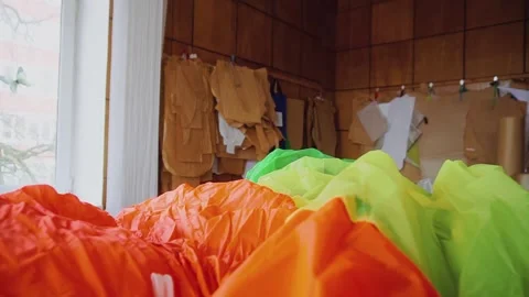 Bright fabrics on table in parachute manufacturing workshop Stock Footage 236907638