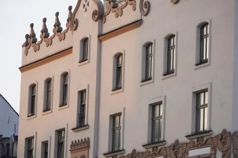 The bright facade of the building in the rays of the setting sun, the old tow Stock Photos