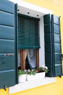 Bright facades and windows in the iconic island village of Burano, Venice Stock Photos