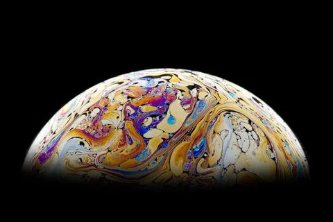 Bright fantastic patterns on the surface of a soap bubble. Stock Photos