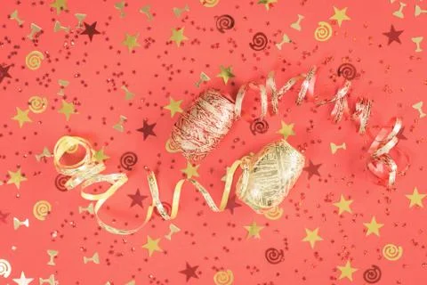 Bright festive confetti and ribbons coral flat lay Stock Photos