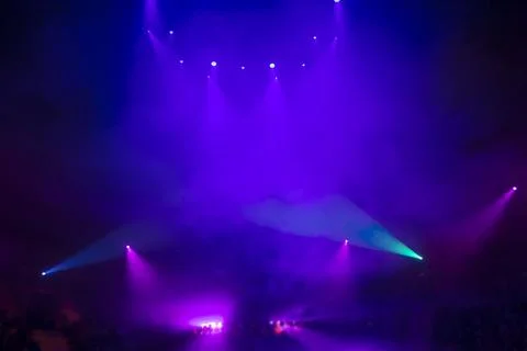 Bright festive multi-colored stage lighting with optical flare and rays from Stock Photos