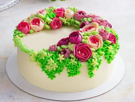 Bright festive white cake with bright flowers made of cream, a wedding cake, Stock Photos