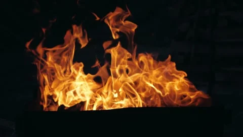 Bright fire and flame burns in a red-hot stone. Beautiful orange flame tongue on Stock Footage 147653451