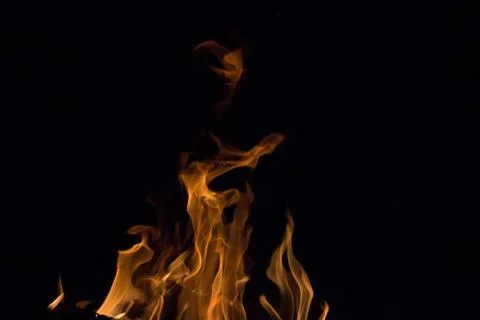 Bright fire on a black background at night Stock Photos