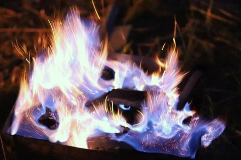 Bright fire with blue flashes of flame Stock Photos