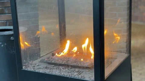 Bright fire burning inside modern glass fireplace Stock-Footage 336458583